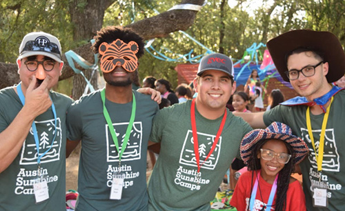 5 campers dressed up in silly costumes