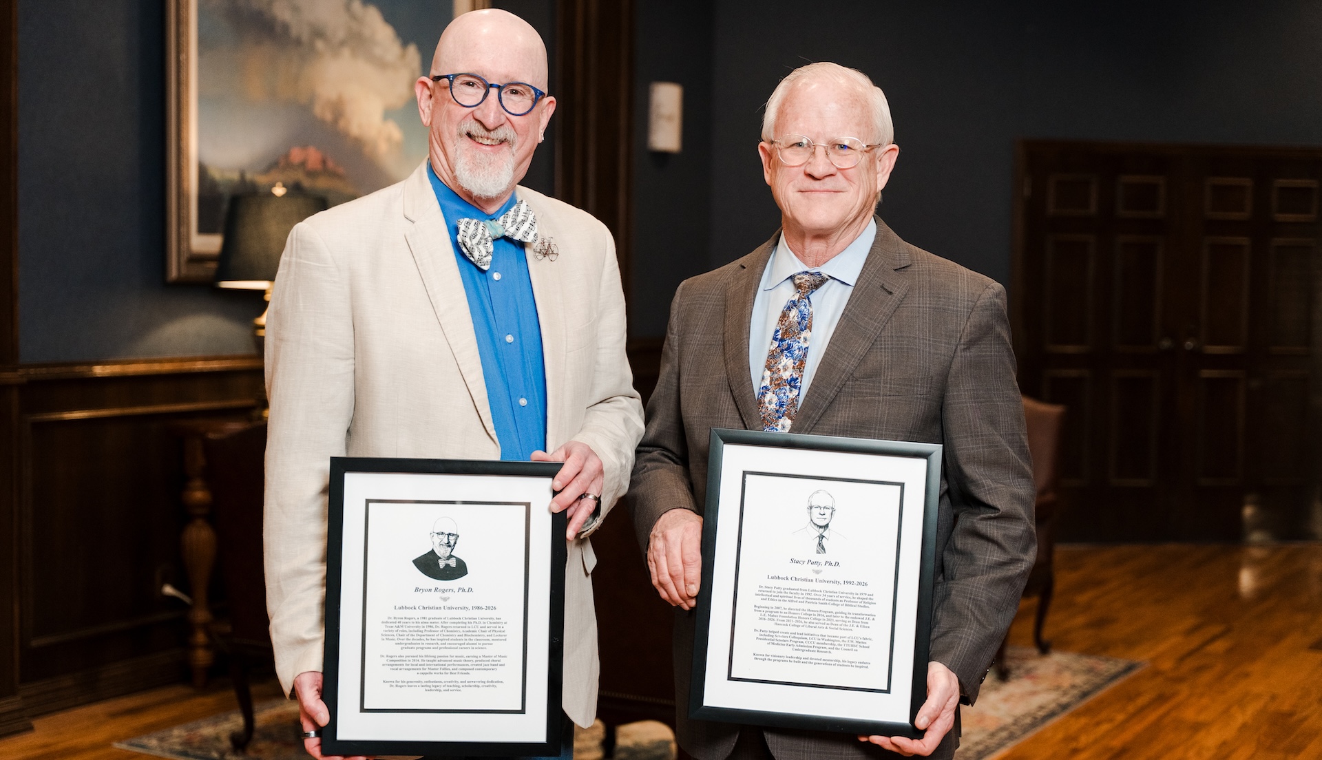 Byron Rogers and Stacy Patty holding their retirement plaques