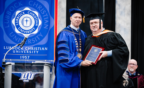 Tony Parnell standing next to President McDowell receiving his award.