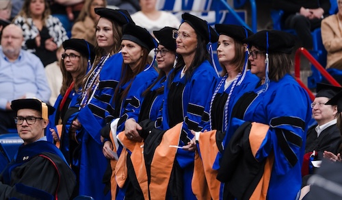 7 of the nursing doctorates standing being recognized at commencement