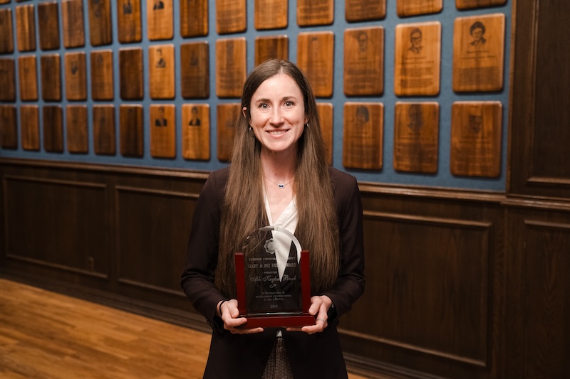 Abbi Brock posing with her award