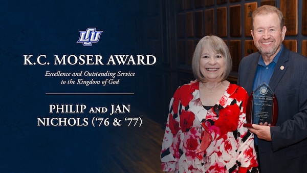 Philip and Jan Nichols holding their award with the award logo to their left