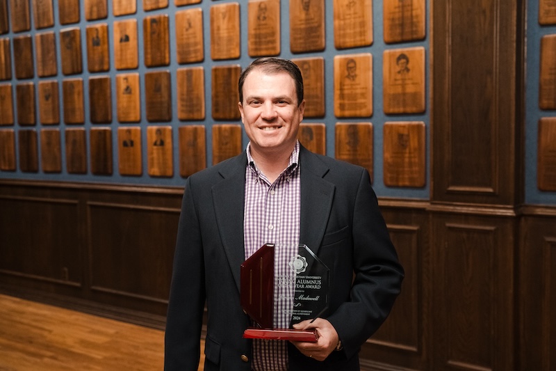 Jordan Madewell posing with his award