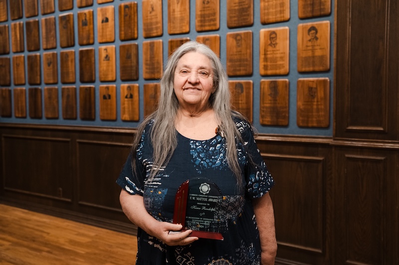 Karen Randolph posing with his award