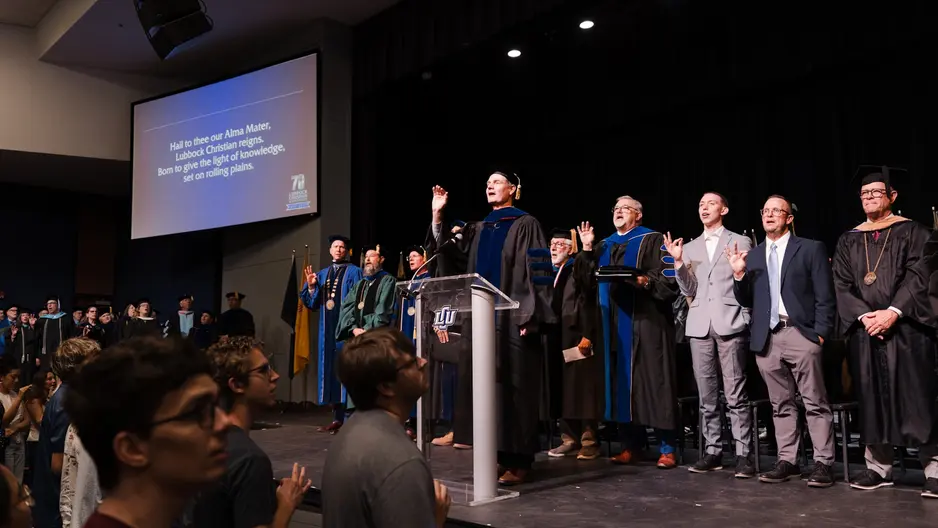Philip Camp leading a song on the stage at open chapel