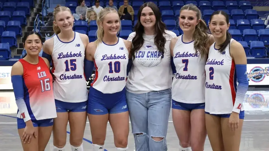 LCU Senior Volleyball players and student coach posing before the game Wednesday night