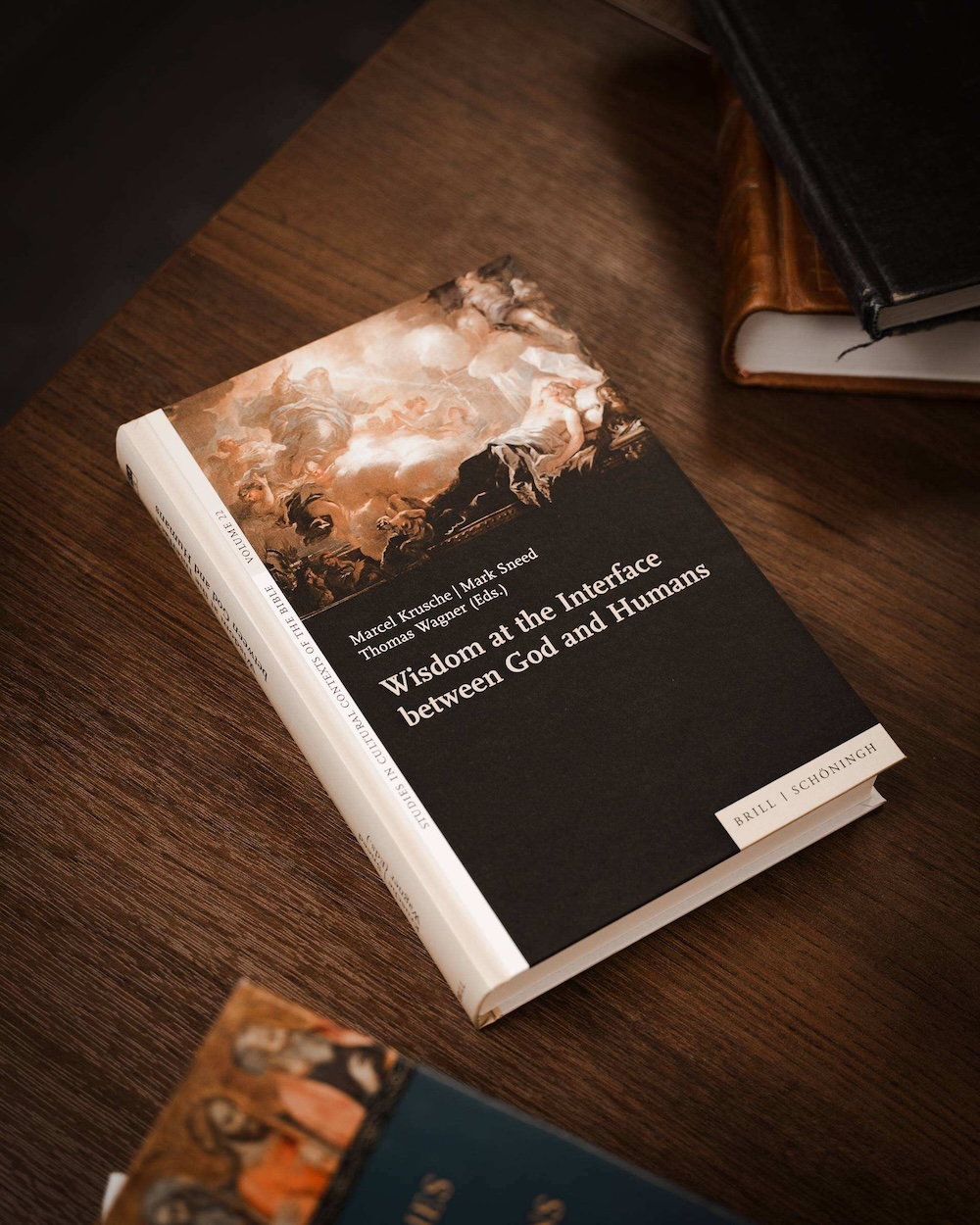 A volume on Wisdom studies co-edited by Dr. Sneed rests on a table.