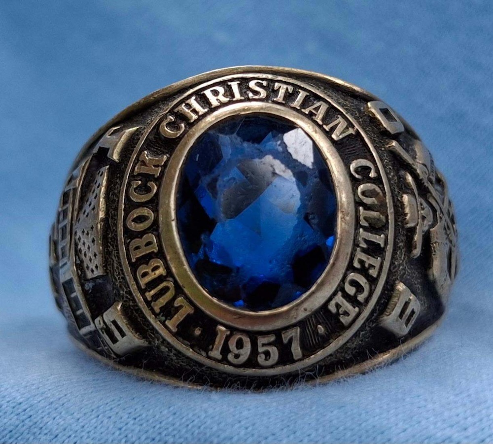Lubbock Christian College class ring belonging to Lynn Sherrod on a blue backdrop.
